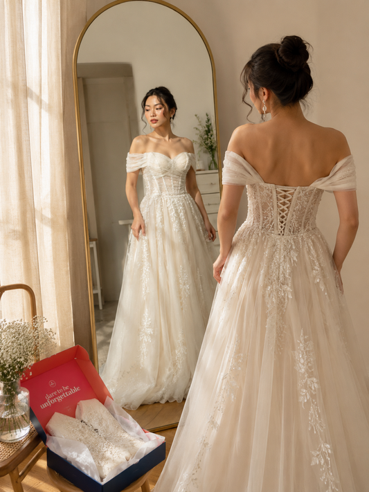A bride in a wedding dress looking at herself in a mirror